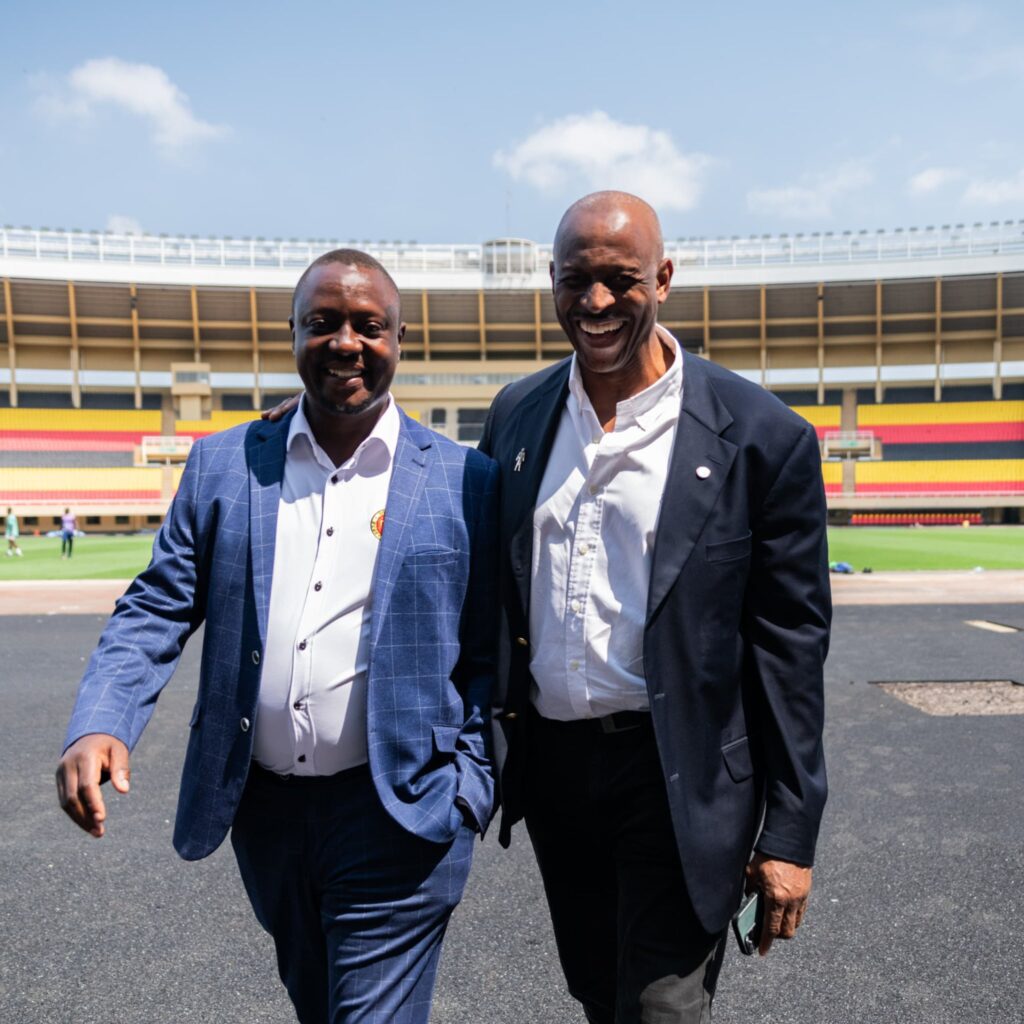 The President of Uganda Rugby Union (L) takes a tour of the Mandela National Stadium in Kampala with the Rugby Africa President, Herbert Mensah (R)